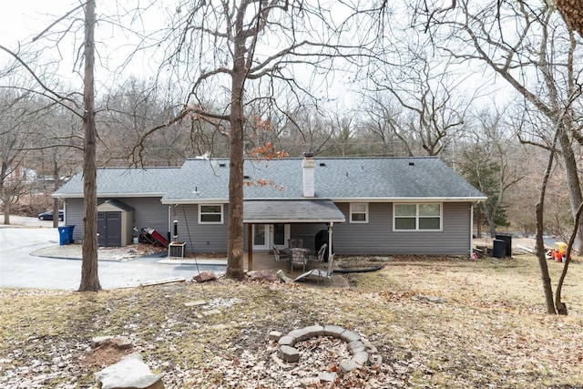 rear view of house featuring a patio and central air condition unit