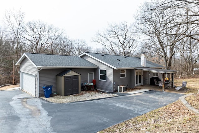 view of home's exterior with a garage and central air condition unit