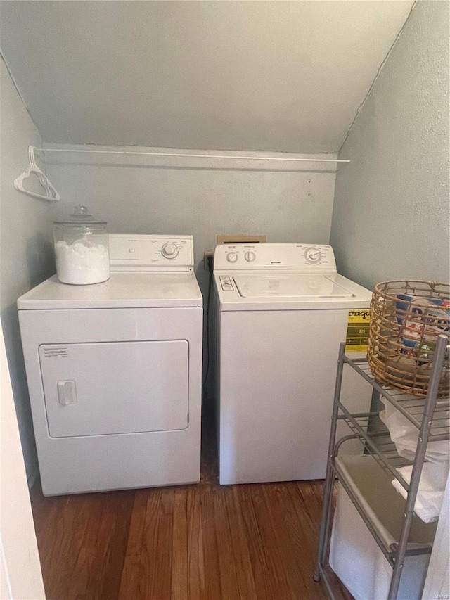 clothes washing area featuring dark hardwood / wood-style flooring and washing machine and dryer