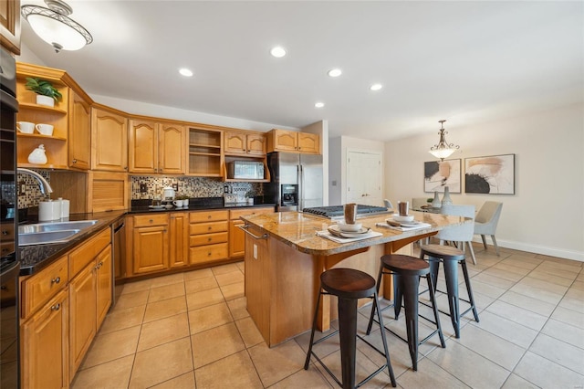 kitchen with a breakfast bar, open shelves, appliances with stainless steel finishes, backsplash, and a center island