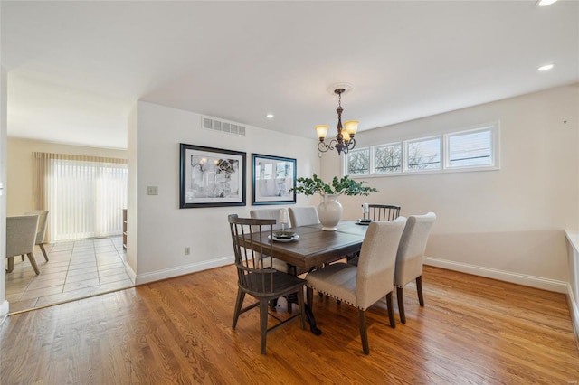 dining space with visible vents, baseboards, a chandelier, light wood-type flooring, and recessed lighting