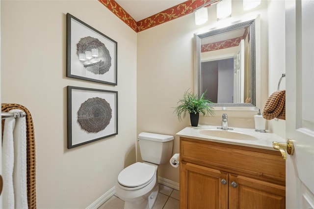 bathroom with vanity, tile patterned floors, toilet, and baseboards