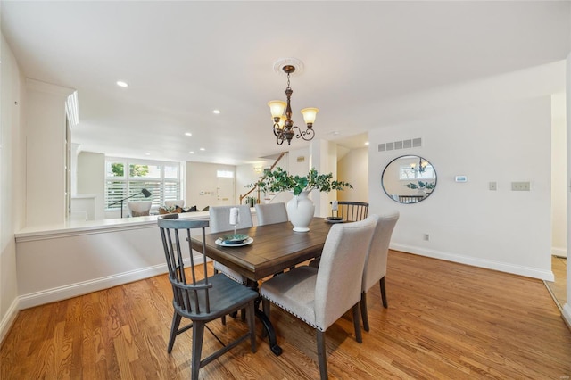 dining room featuring visible vents, baseboards, light wood-type flooring, recessed lighting, and an inviting chandelier