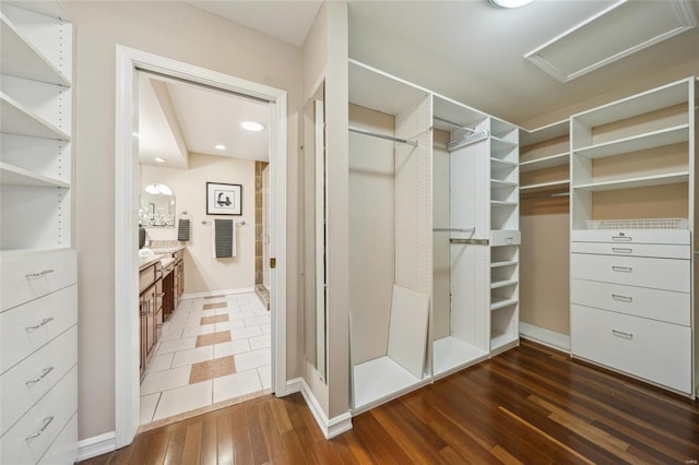 spacious closet featuring attic access and wood-type flooring