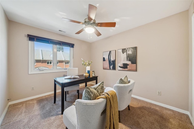 carpeted office space with visible vents, ceiling fan, and baseboards