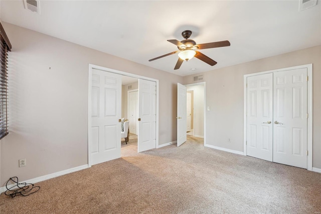 unfurnished bedroom featuring visible vents, baseboards, and light carpet