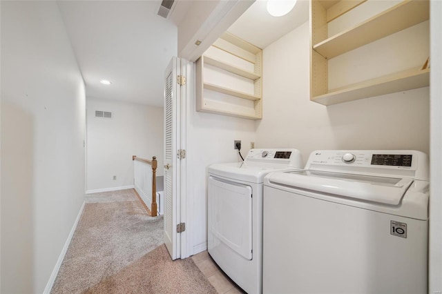 laundry area featuring washer and dryer, laundry area, baseboards, and visible vents