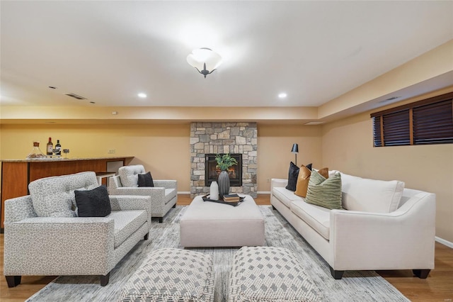 living area with visible vents, recessed lighting, baseboards, and wood finished floors