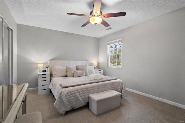 bedroom featuring ceiling fan, carpet flooring, and a textured ceiling