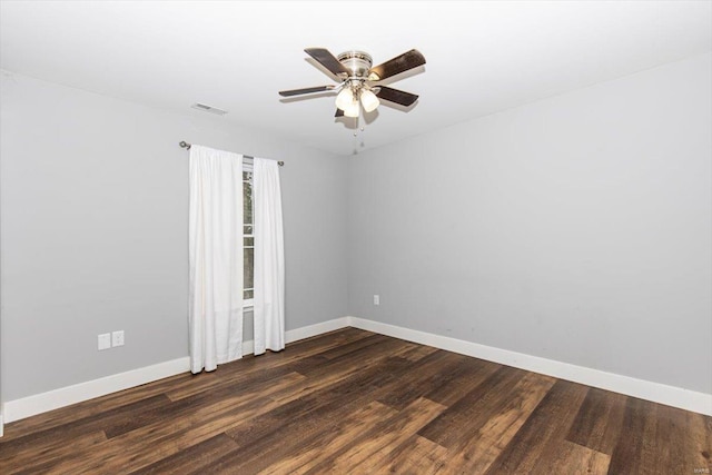 empty room featuring dark wood-type flooring and ceiling fan