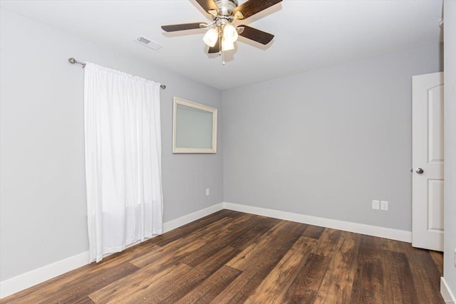 empty room featuring ceiling fan and dark hardwood / wood-style flooring