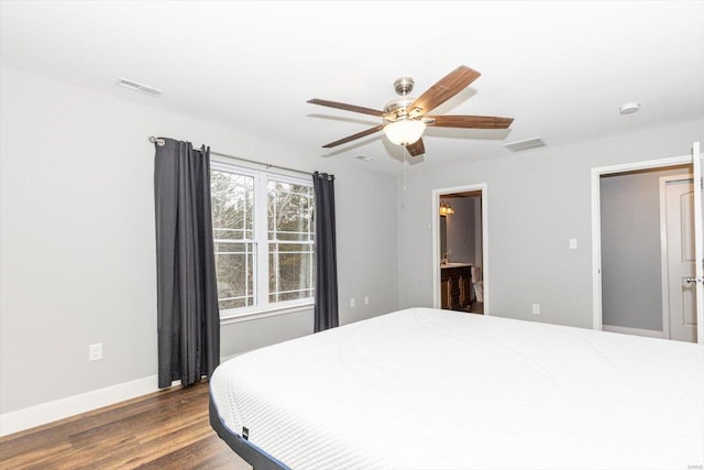 bedroom featuring ceiling fan, ensuite bathroom, and dark hardwood / wood-style floors