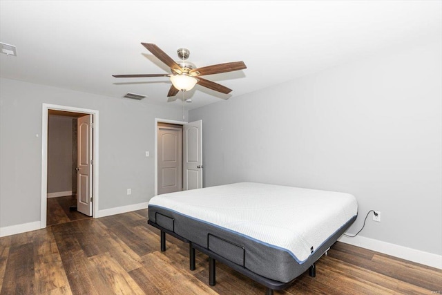 bedroom with dark hardwood / wood-style floors and ceiling fan