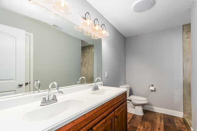 bathroom with vanity, hardwood / wood-style floors, and toilet