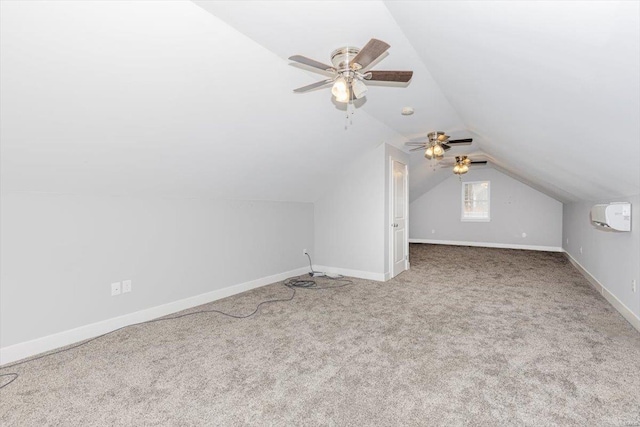 additional living space with lofted ceiling, light colored carpet, and ceiling fan