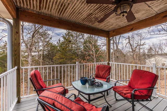 wooden deck featuring ceiling fan