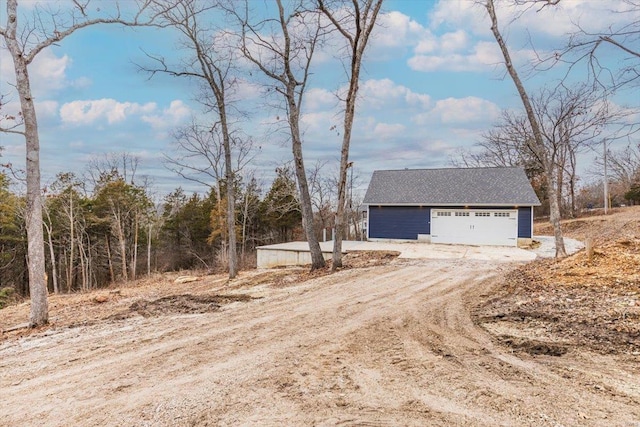 exterior space with a garage and an outdoor structure