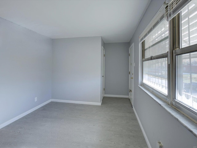 unfurnished room with light wood-type flooring