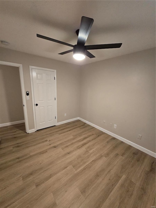 spare room featuring ceiling fan and light hardwood / wood-style floors