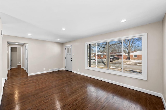 interior space featuring recessed lighting, visible vents, dark wood finished floors, and baseboards