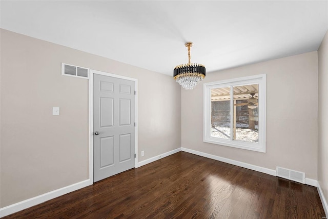 unfurnished dining area featuring a notable chandelier, baseboards, visible vents, and dark wood-style flooring