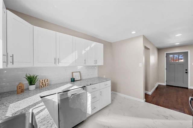 kitchen with tasteful backsplash, baseboards, light stone countertops, marble finish floor, and stainless steel dishwasher