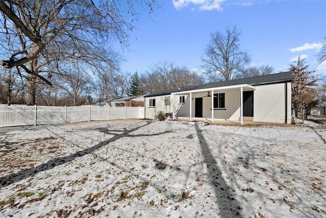 rear view of property featuring fence private yard