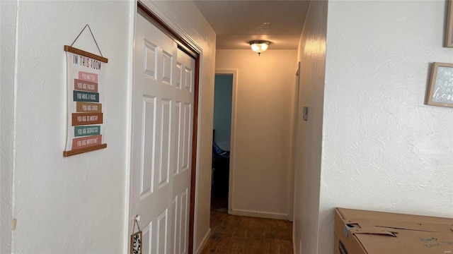 corridor with dark hardwood / wood-style flooring