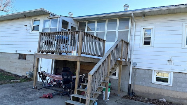 rear view of house featuring a deck