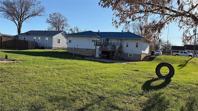 back of house featuring a yard and a deck