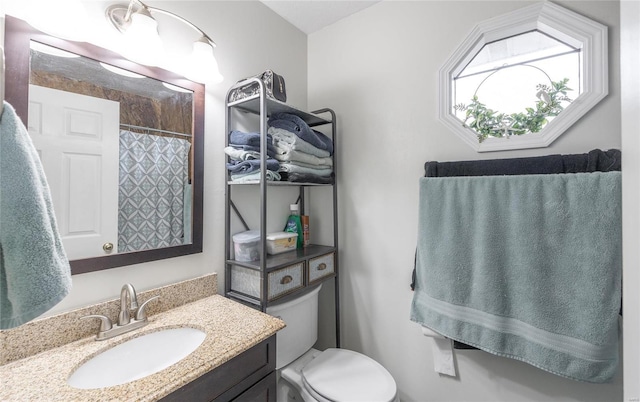 bathroom with vanity, toilet, and a shower with shower curtain