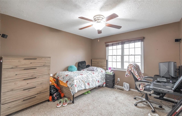 carpeted bedroom with ceiling fan and a textured ceiling