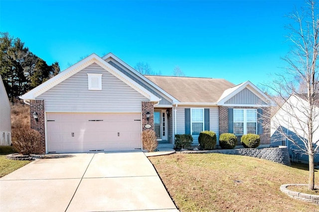 single story home with a front yard, brick siding, driveway, and an attached garage