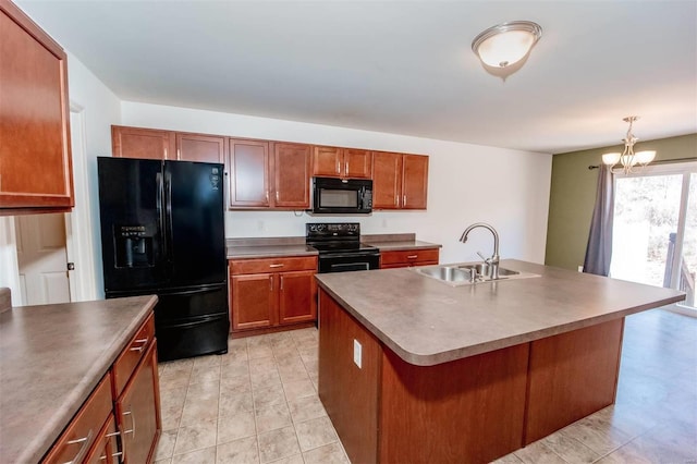 kitchen featuring dark countertops, black appliances, brown cabinetry, and a sink