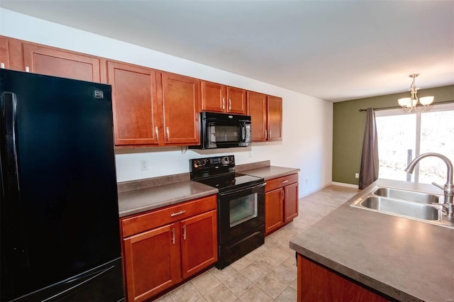 kitchen featuring a chandelier, a sink, hanging light fixtures, black appliances, and brown cabinetry