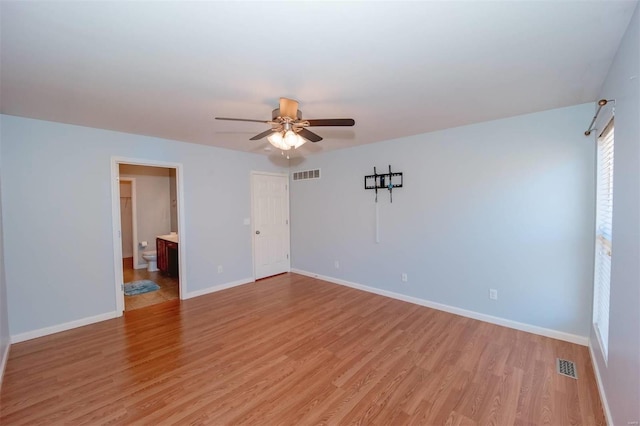 unfurnished bedroom featuring light wood finished floors, baseboards, visible vents, and ceiling fan