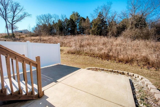 view of yard with fence and a patio