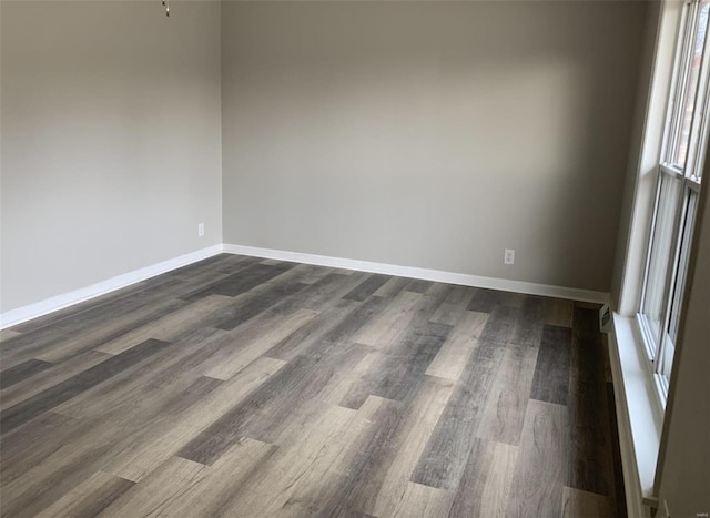 empty room featuring dark hardwood / wood-style flooring