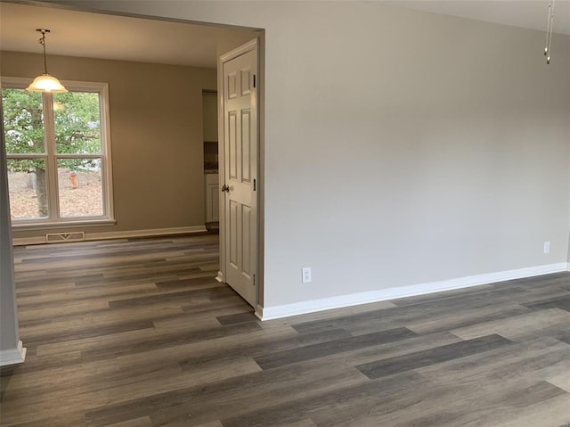 spare room with dark hardwood / wood-style flooring