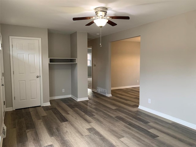 unfurnished bedroom with dark hardwood / wood-style floors, ceiling fan, and a closet