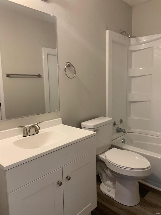 full bathroom with wood-type flooring, bathtub / shower combination, vanity, and toilet