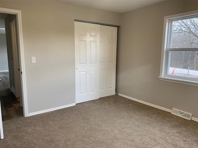 unfurnished bedroom featuring a closet and carpet flooring