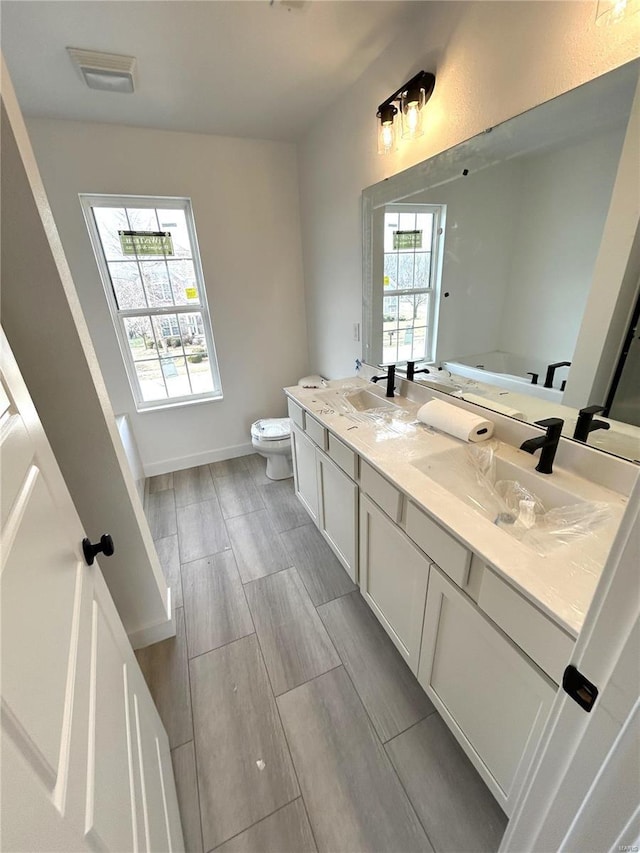 bathroom featuring vanity and toilet