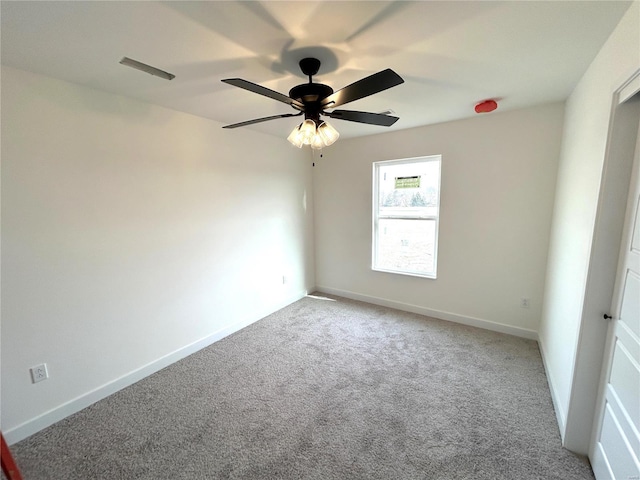 carpeted empty room featuring ceiling fan