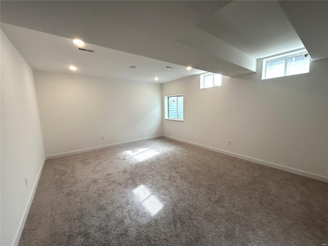 basement featuring carpet and a healthy amount of sunlight