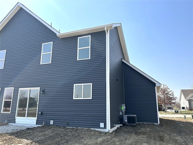 rear view of property with central AC unit