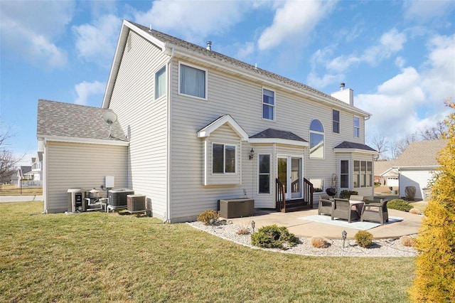 rear view of property featuring a patio, a chimney, a lawn, entry steps, and cooling unit