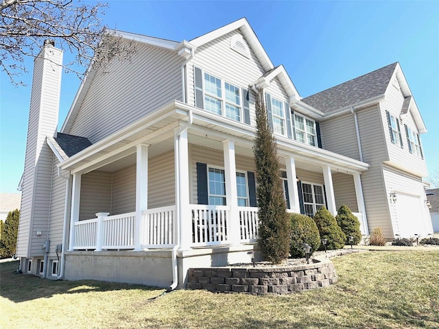 view of front of property with a porch, a front yard, and a chimney