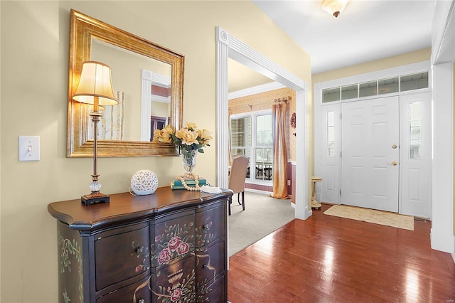 entrance foyer with ornamental molding and wood finished floors