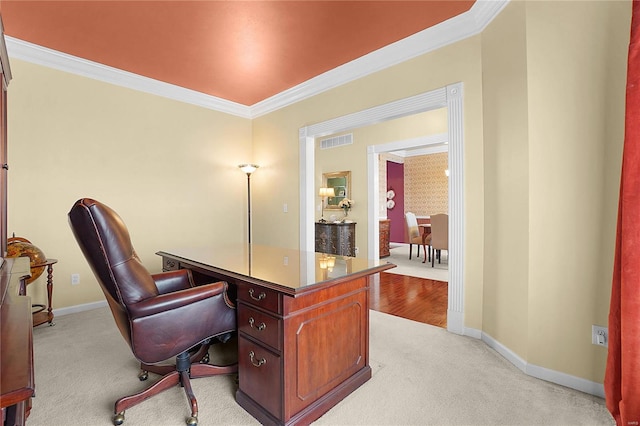 home office featuring baseboards, crown molding, and light colored carpet